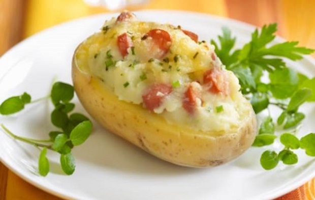 Baked potato stuffed with beef sausages